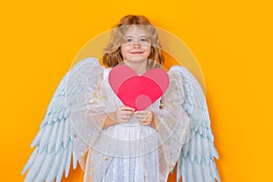 Paper heart, Child with angel wings hold red heart. Heart symbol love and valentines day. Valentine's day. Blonde