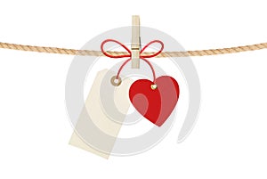 Paper heart and empty tag hang on cord isolated on white
