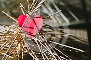 The paper heart lies on the wooden sticks. idea