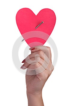 Paper heart pierced by a nail.