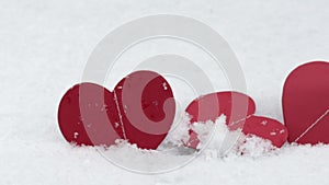 paper hearts harland red color isolated on snow ice