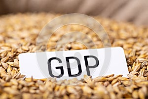 Paper with inscription GDP on barley grain