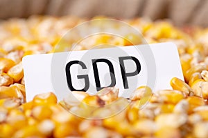 Paper with inscription GDP on corn