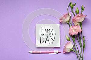 Paper with inscription HAPPY TEACHER`S DAY and flowers on violet background. Space for text