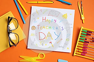 Paper with inscription HAPPY TEACHER`S DAY, glasses and stationery on orange background