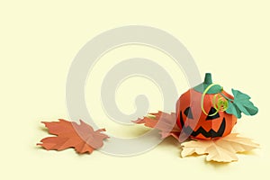 Paper Jack-o-lantern with autumn leaves