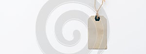 Paper label with rope on white background. Sale in modern design. Minimal concept. Horizontal long banner for web design. Flat lay