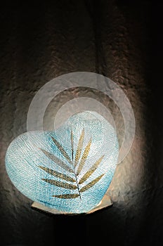 Paper lamp heart blue with dry leaf on in the dark