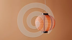 A paper lantern hanging against a clean pastel color wall, represents the illuminating spirit of hope and joy of Lunar New Year