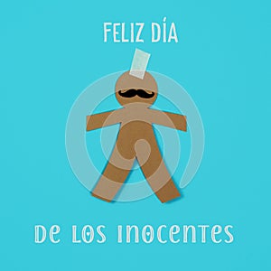 Paper man and text happy innocents day in spanish