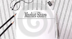 Paper with MARKET SHARE on a table on charts
