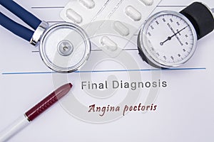 Paper medical form with the diagnosis of Angina pectoris on which lie the stethoscope, blood pressure monitor, white tablets or pi