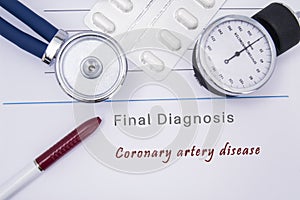 Paper medical form with a text diagnosis of Coronary artery disease on which lie the stethoscope, blood pressure monitor, white ta