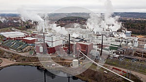 Paper mill in BorlÃ¤nge, Sweden with smoking chimneys. Aerial view.