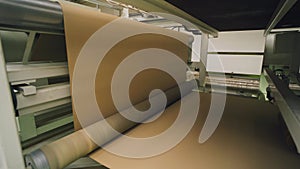 Paper mill. The paper moves automatically in the paper machine. Paper industry.