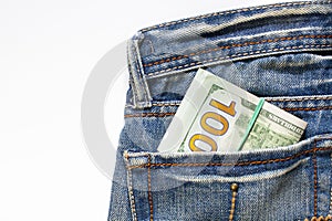 Paper money in a denim pocket on white.