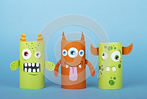 Paper monsters on a blue background. Handmade concept, creative idea from toilet tube