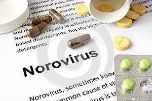Paper with norovirus and pills.