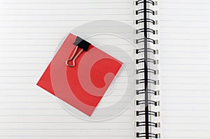 Paper note with clip on notebook