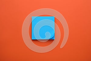 Paper note on orange background, top view