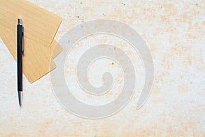 Paper note and pen on grunge background