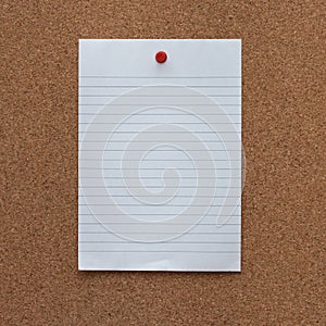 Paper note with pushpin on cork board background