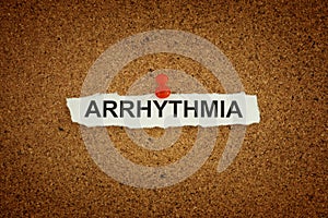 A paper note with the word Arrhythmia on it pinned to a cork board