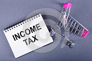 Paper notebook on which Income tax is written