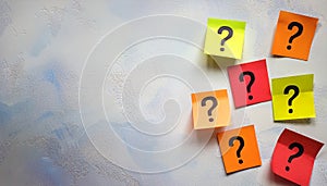 Paper notes with question marks on white background, flat lay. Space for text
