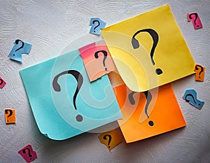 Paper notes with question marks on white background, flat lay. Space for text