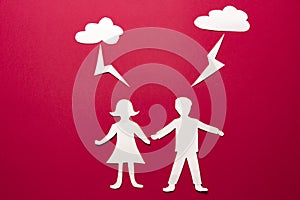 Paper origami people man and woman holding hands under thunderclouds with lightning. Danger and attack concept. Lightning strikes.