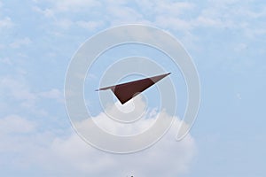 Paper plane against sky with clouds