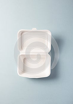 Paper plastic-free food container, vertical top view. Single-use dinnerware non-plastic alternatives concept