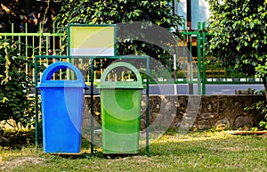 Paper and plastic recycle bin placed in the garden for cleanness. cleanness concept photo