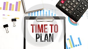 Paper plate with text TIME TO PLAN. Diagram, calculator, notepad and white background