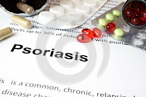 Paper with psoriasis and pills. photo