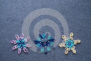 Paper quilling Christmas Crafts in the form of snowflakes from s