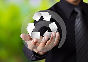 Paper recycle sign in businessman hand