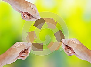 Paper recycle sign in hands