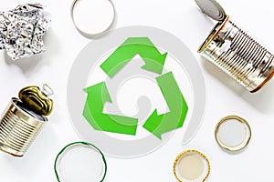 Paper recycle sign with steel garbage on white background top view