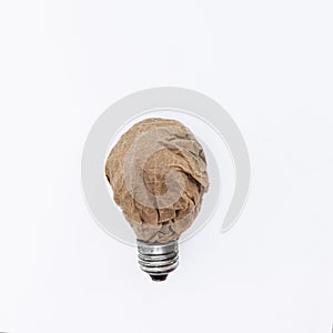 paper recycling ideas concept. Crumpled craft paper in the form of a light bulb.