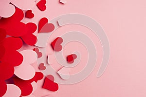 Paper red and pink hearts soar on soft pink color background. Valentine day concept for design, copy space. photo