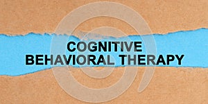 The paper is ripped in the middle. Inside on a blue background it is written - Cognitive Behavioral Therapy