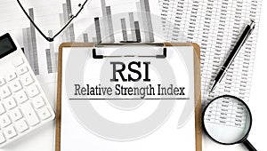 Paper with RSI - Relative Strength Index a table on charts, business concept