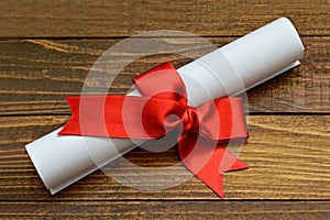 Paper scroll tied with red ribbon