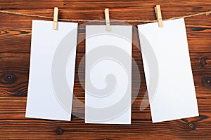 Paper set attach to rope with clothes pins on wooden background - Image