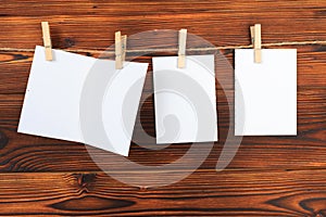 Paper set attach to rope with clothes pins on wooden background - Image