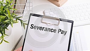 Paper with Severance Pay on a table. Business concept
