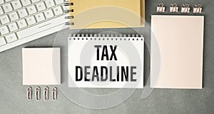 Paper sheet with text TAX DEADLINE, calculator