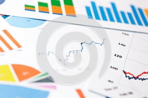 Paper sheets with business graphs and charts